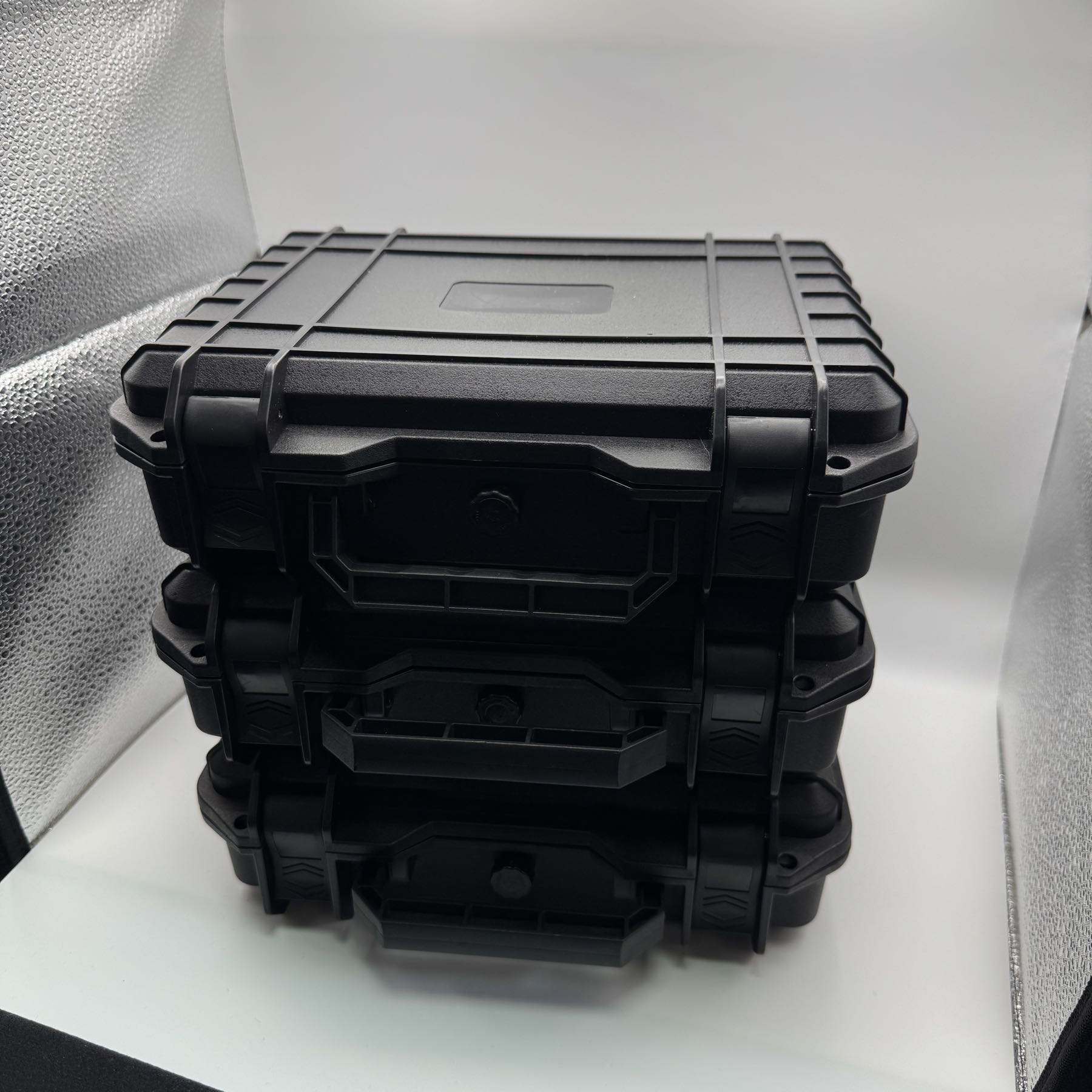 Three MK Bullion hard-shell storage cases stacked on top of each other